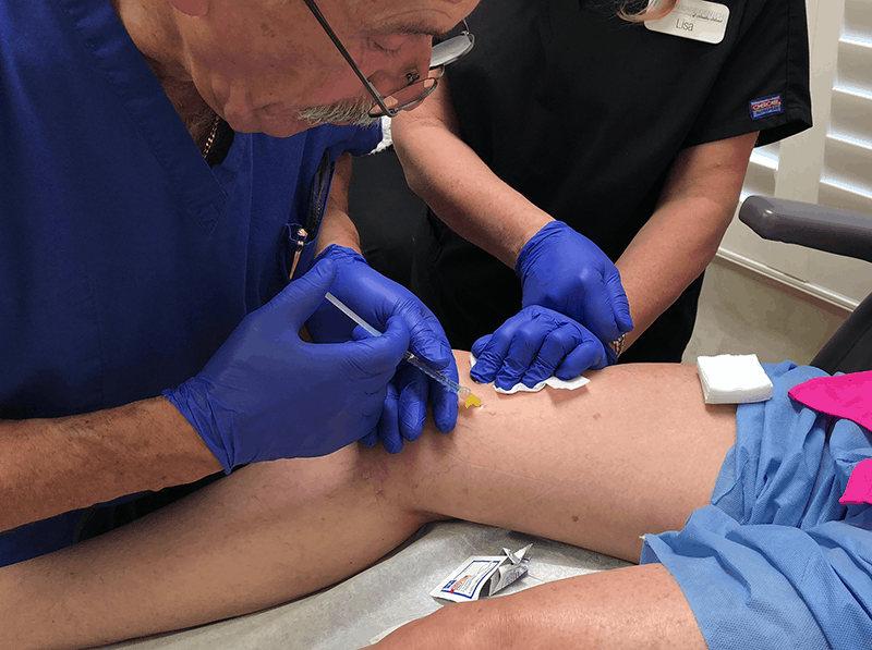 Patient undergoing Sclerotherapy gets injections in her thigh